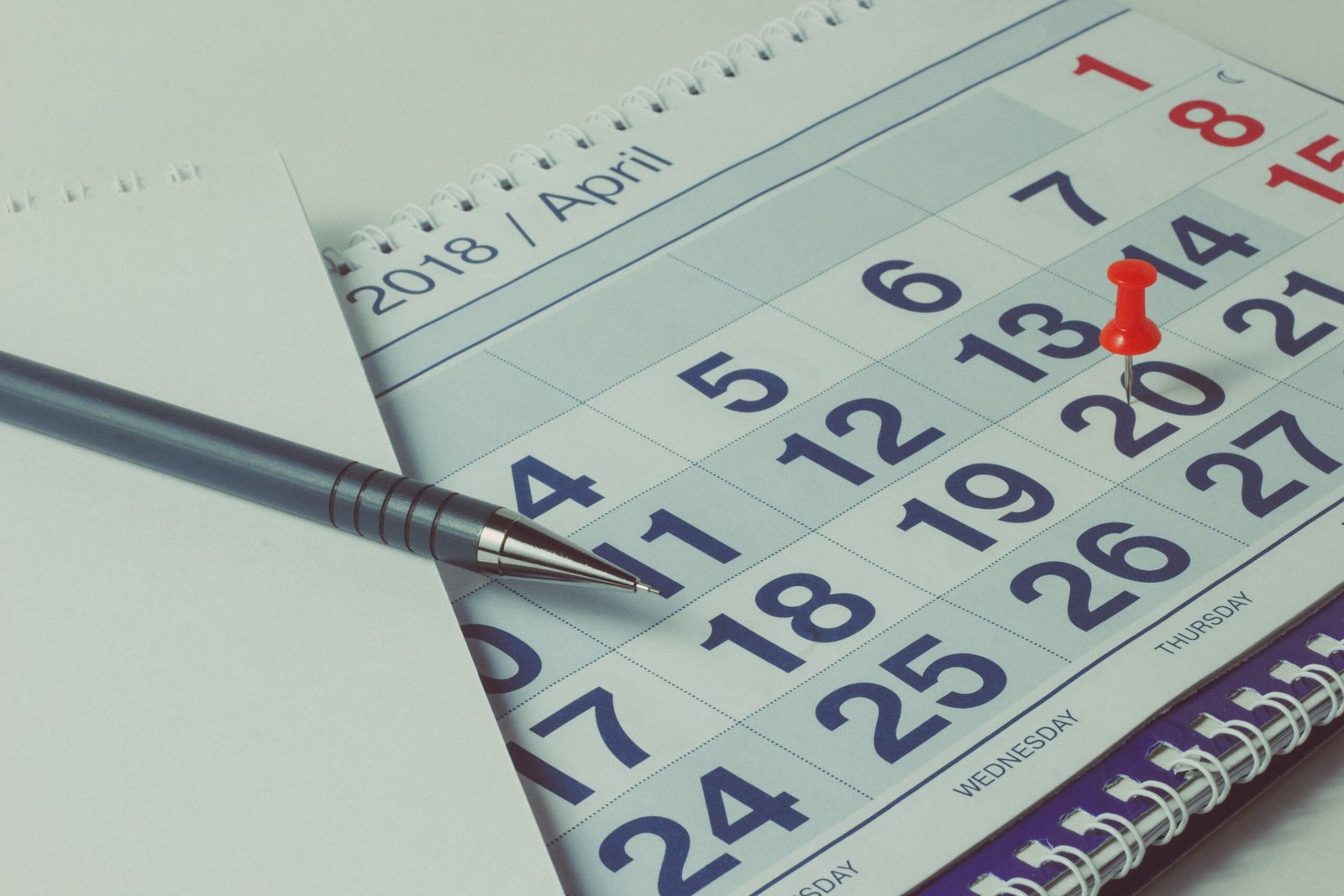 sheet of a calendar and a pen close-up