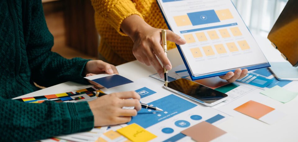 UX developer and ui designer brainstorming about mobile app int Redesign vs. Refresh Your Website: Which Is Better for Your Company?