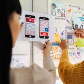 Close up ux developer and ui designer brainstorming interface wireframe design.Creative digital development agency Close up ux developer and ui designer brainstorming interface wireframe design.Creative digital development agency.