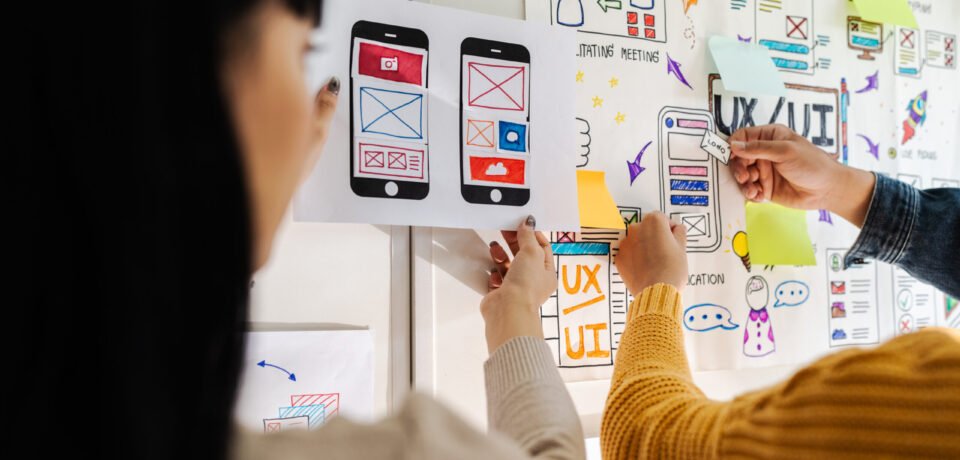 Close up ux developer and ui designer brainstorming interface wireframe design.Creative digital development agency Close up ux developer and ui designer brainstorming interface wireframe design.Creative digital development agency.