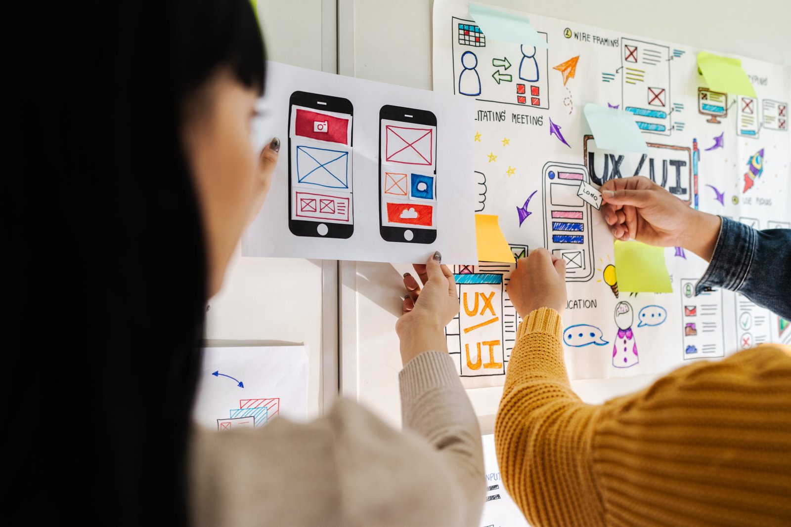 Close up ux developer and ui designer brainstorming interface wireframe design.Creative digital development agency.