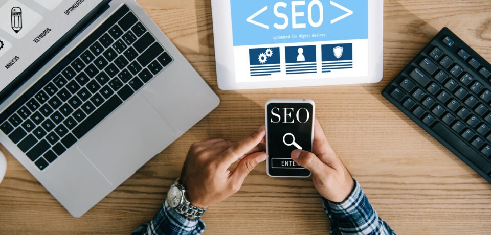 cropped shot of professional seo manager using digital devices at workplace