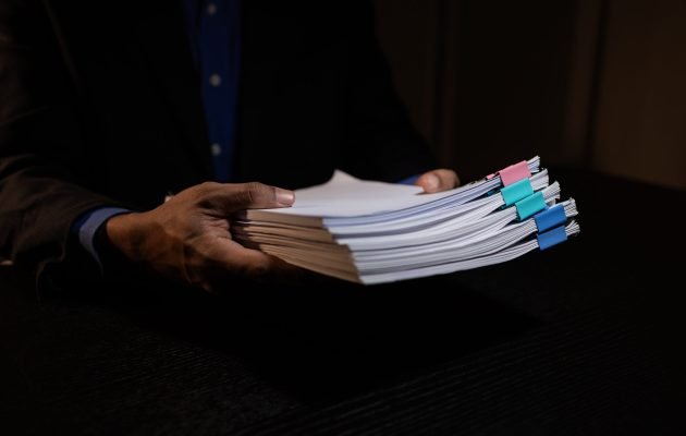 a businessman works overtime is his accounting firm’s office until late at night, an entrepreneur remains at his export company because he has a lot of customer documents to check a businessman works overtime is his accounting firm's office until late at night, an entrepreneur remains at his export company because he has a lot of customer documents to check