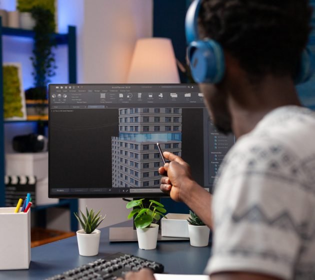African american architect person analyzing skyscraper construction plan African american architect person analyzing skyscraper construction plan looking at building concept working remote from home. Young engineer developing business corporate workplace sketch