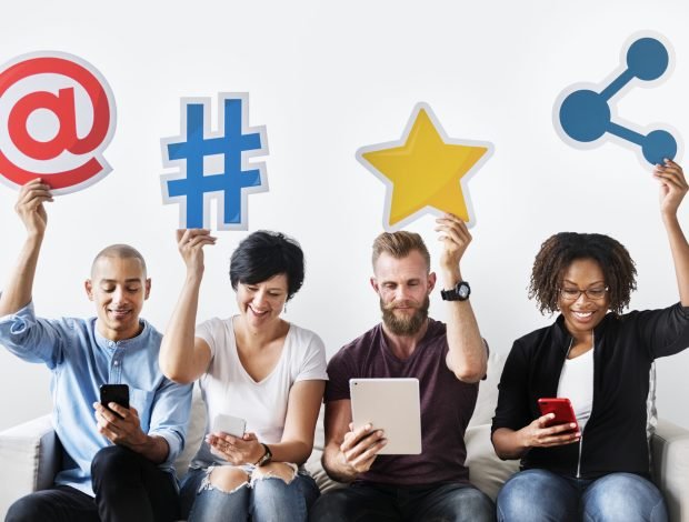 People holding an social media icon People holding an social media icon