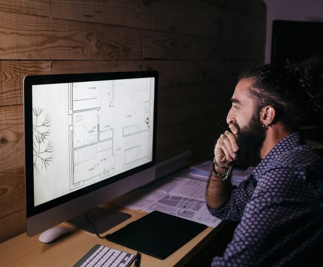 Young architect working hard on a new project at home at night Young architect working hard on a new project at home at night